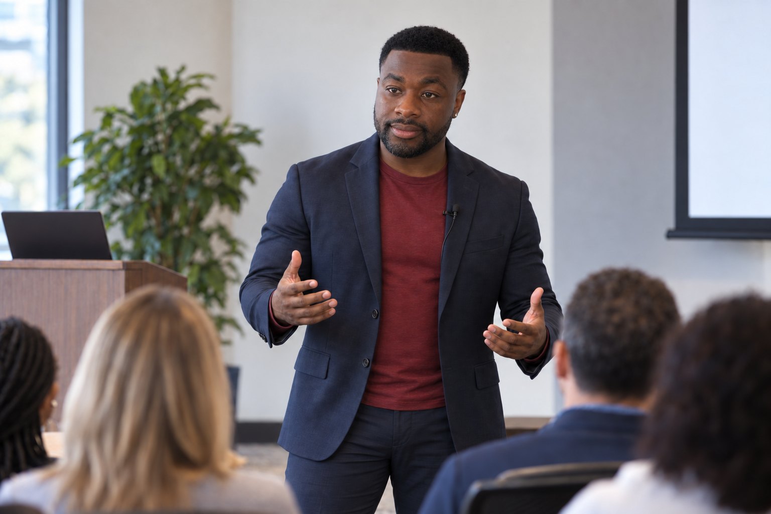 Joshua Peterson speaking to a seated audience during a leadership session